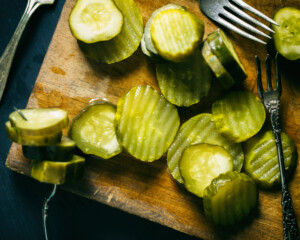 A cutting board with pickles
