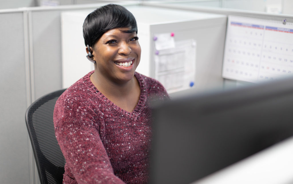 Photo of smiling woman on phone