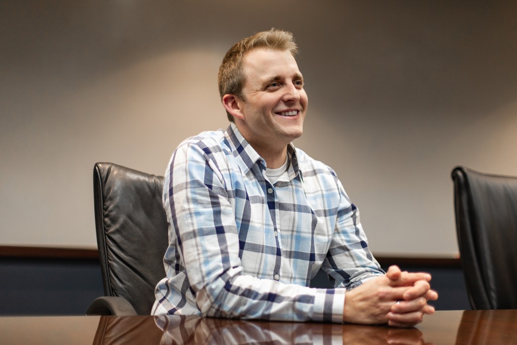 Photo of smiling man at a desk