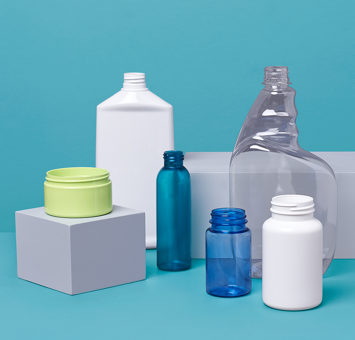 Photo of various plastic bottles on blue background