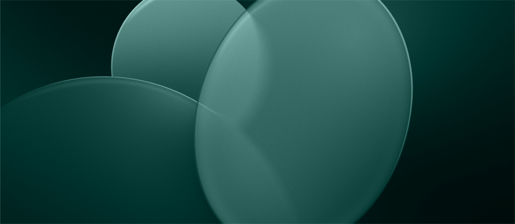 Abstract teal overlapping circular discs with glossy gradients on a dark green background.